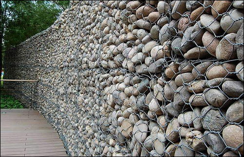 Gabion rock wall of metal wire cage baskets